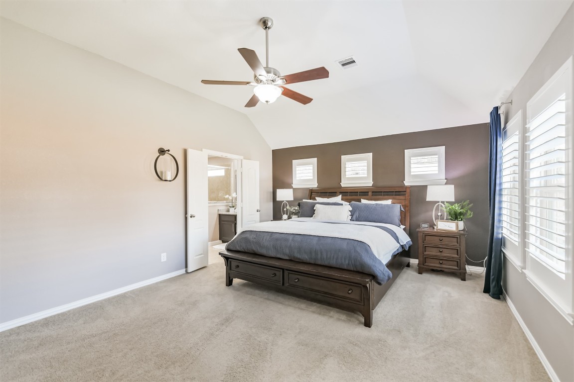9622 Invergarry Way Tomball, TX 77375 - Photo 15 of 32 a spacious bedroom with a bed lamp and a large window