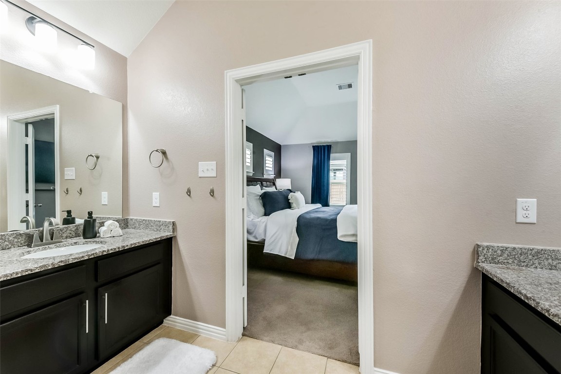 9622 Invergarry Way Tomball, TX 77375 - Photo 20 of 32 a en suite bathroom with a double vanity sink and a mirror