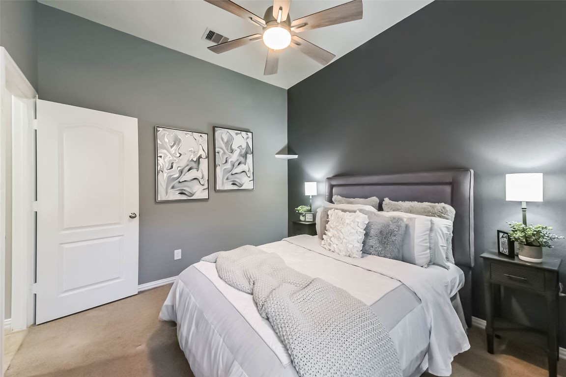 9622 Invergarry Way Tomball, TX 77375 - Photo 24 of 32 a bedroom with a bed and a chandelier