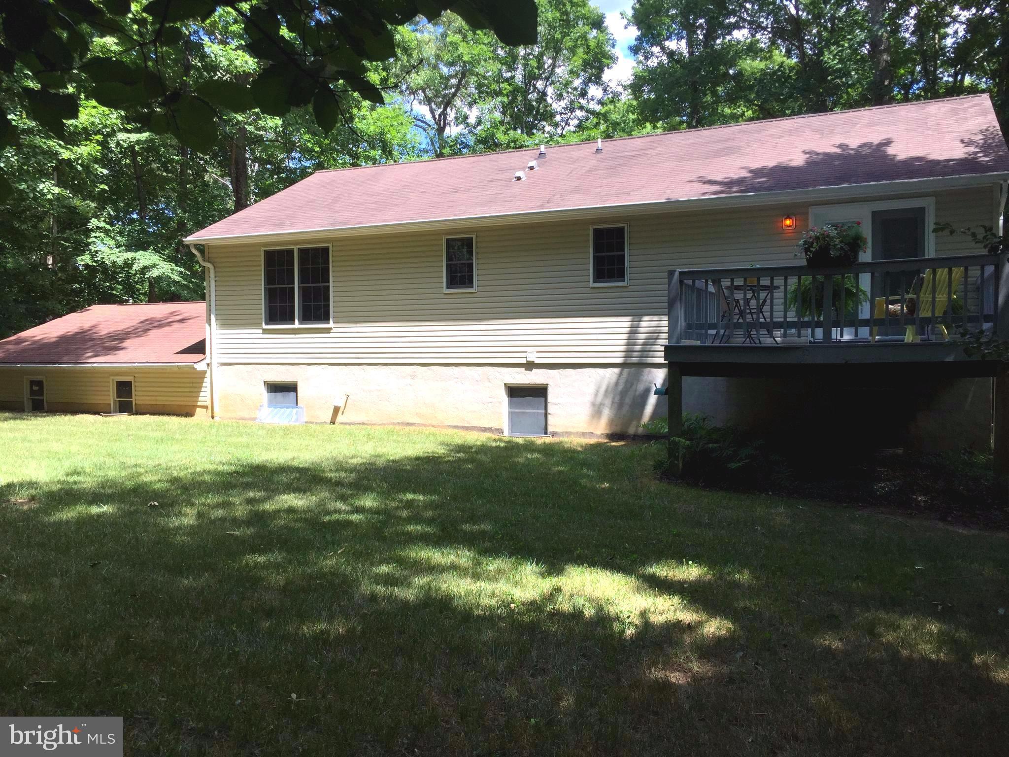 12740 Blair Road Lusby, MD 20657 - Photo 22 of 30 a front view of house with yard and outdoor seating