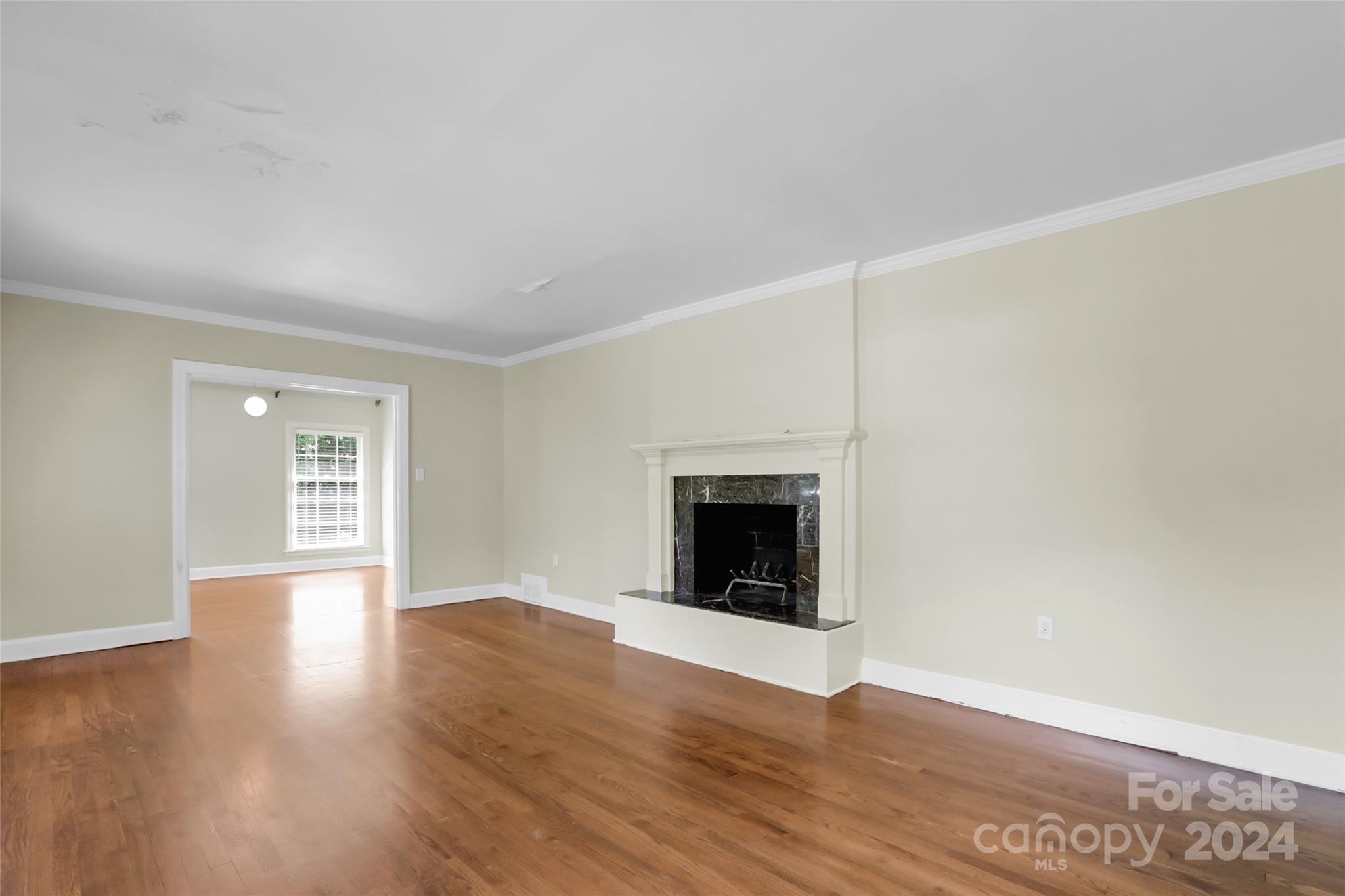 1408 Sterling Road Charlotte, NC 28209 - Photo 11 of 28 a view of an empty room with wooden floor fireplace and a window
