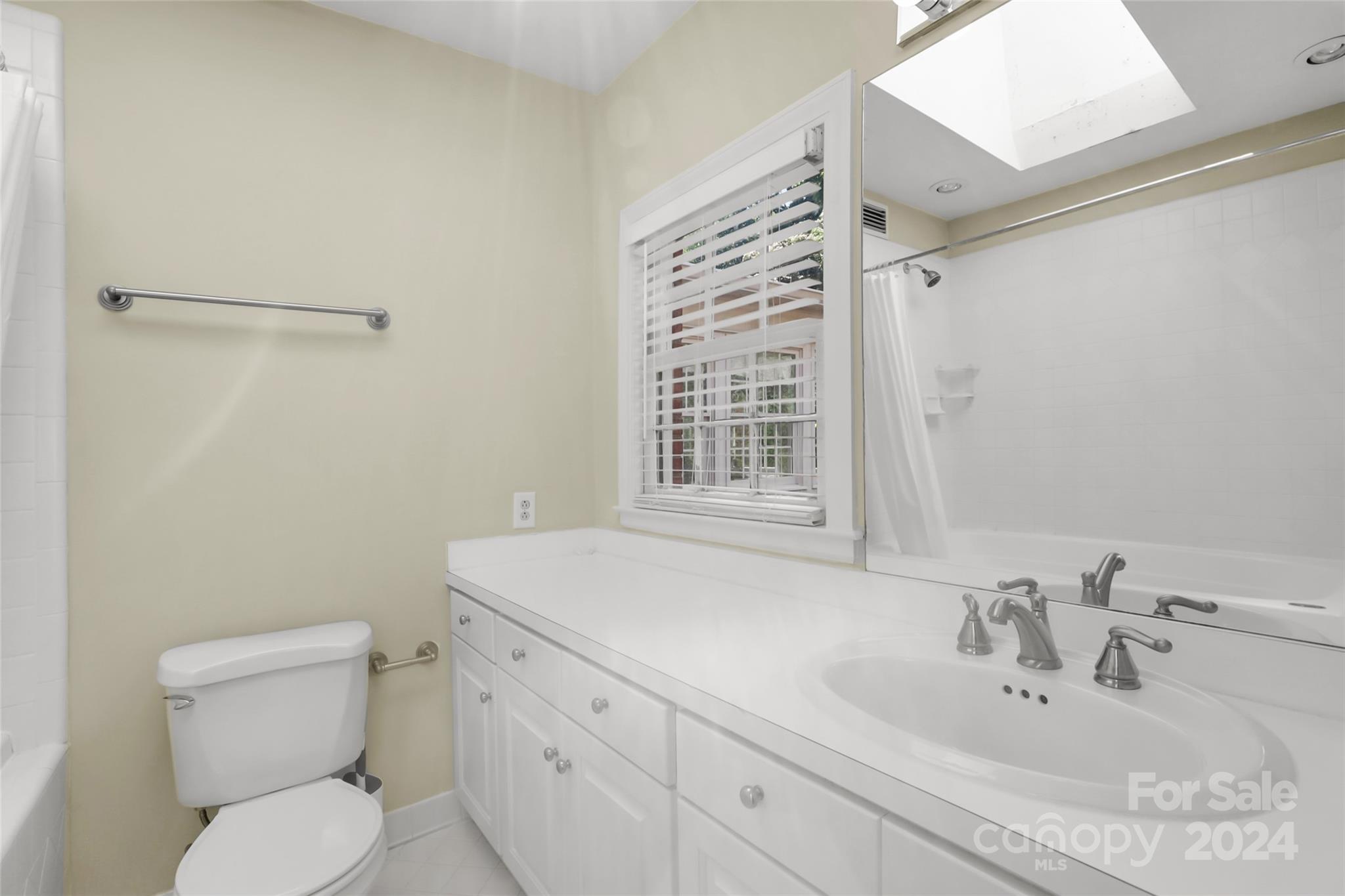 1408 Sterling Road Charlotte, NC 28209 - Photo 19 of 28 a bathroom with a sink a toilet and shower