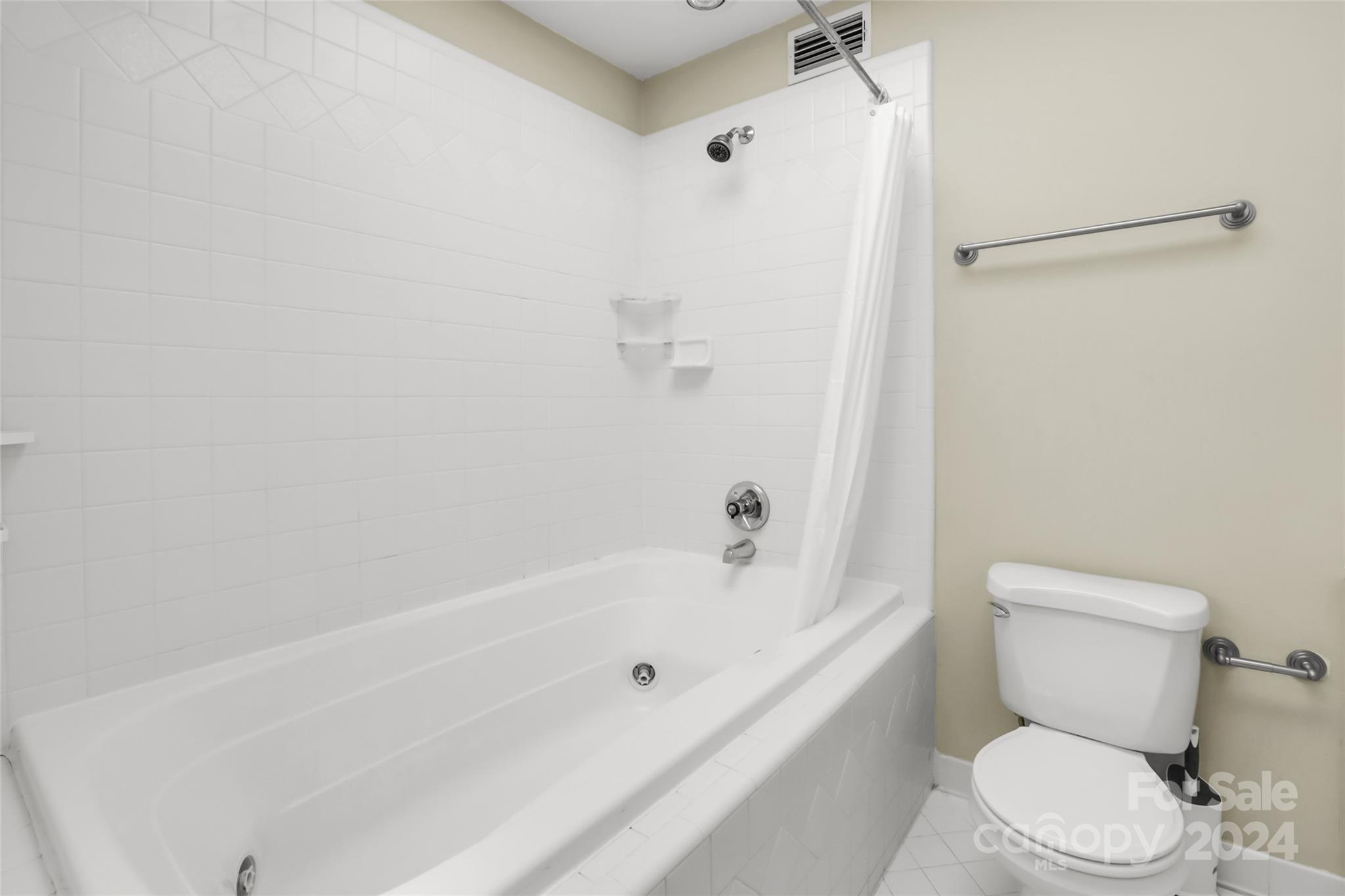 1408 Sterling Road Charlotte, NC 28209 - Photo 20 of 28 a white toilet sitting next to a bath tub