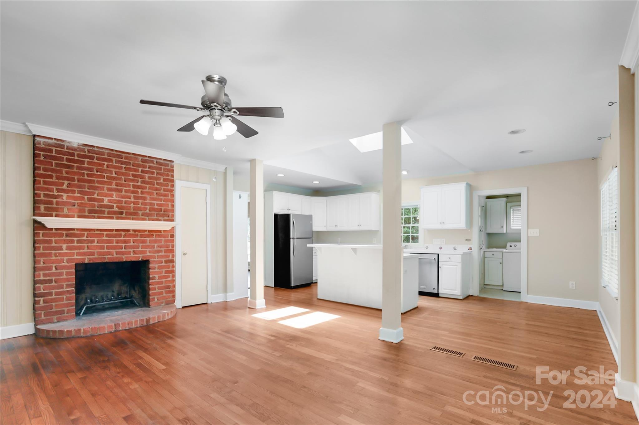 1408 Sterling Road Charlotte, NC 28209 - Photo 4 of 28 a view of empty room with a fireplace and wooden floor