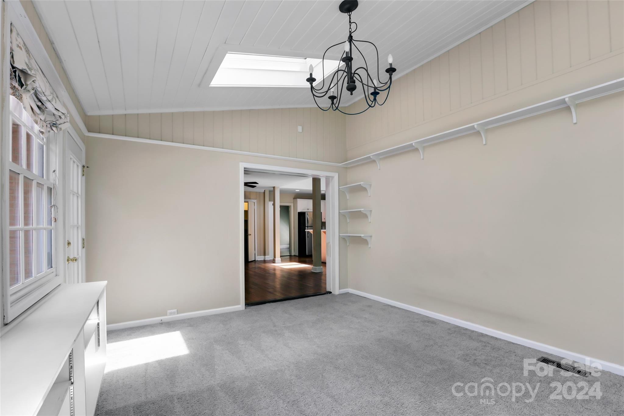 1408 Sterling Road Charlotte, NC 28209 - Photo 7 of 28 a view of a hallway with wooden floor and chandelier