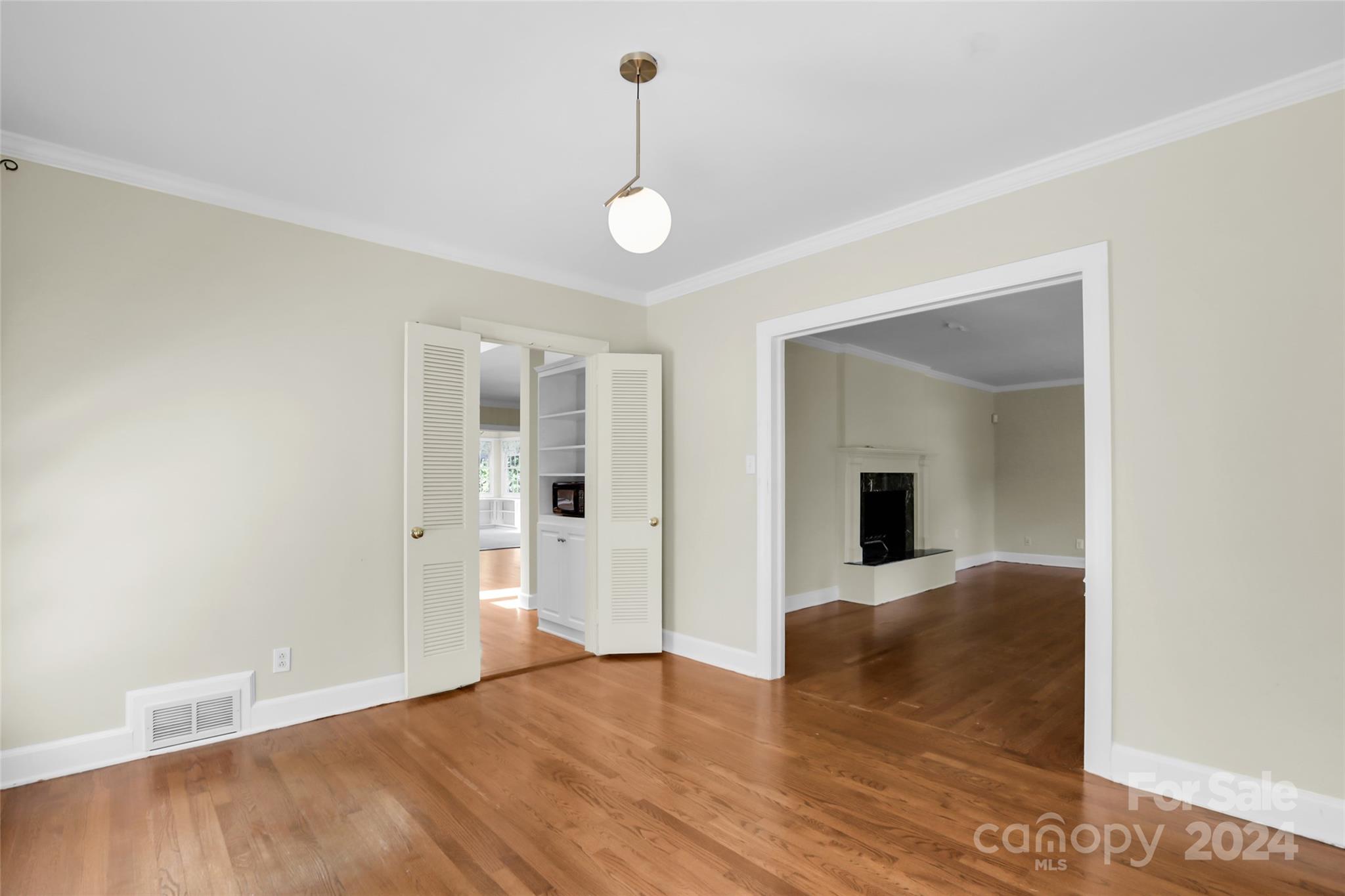 1408 Sterling Road Charlotte, NC 28209 - Photo 9 of 28 a view of a livingroom with wooden floor and a ceiling fan