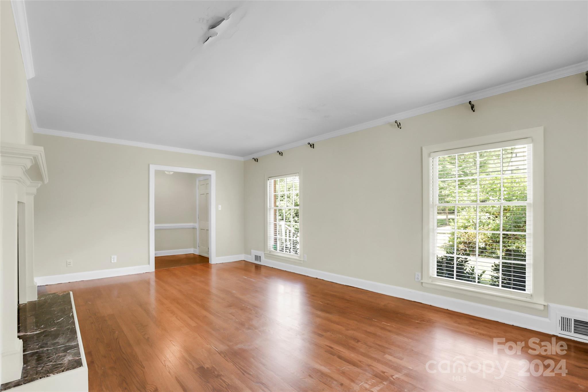 1408 Sterling Road Charlotte, NC 28209 - Photo 10 of 28 a view of an empty room with wooden floor and a window