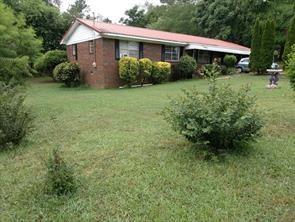 148 Kinman Road Calhoun, GA 30701 - Photo 1 of 1 a view of a house with garden and yard