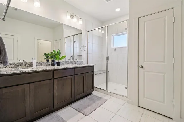 a bathroom with a double vanity sink and a mirror