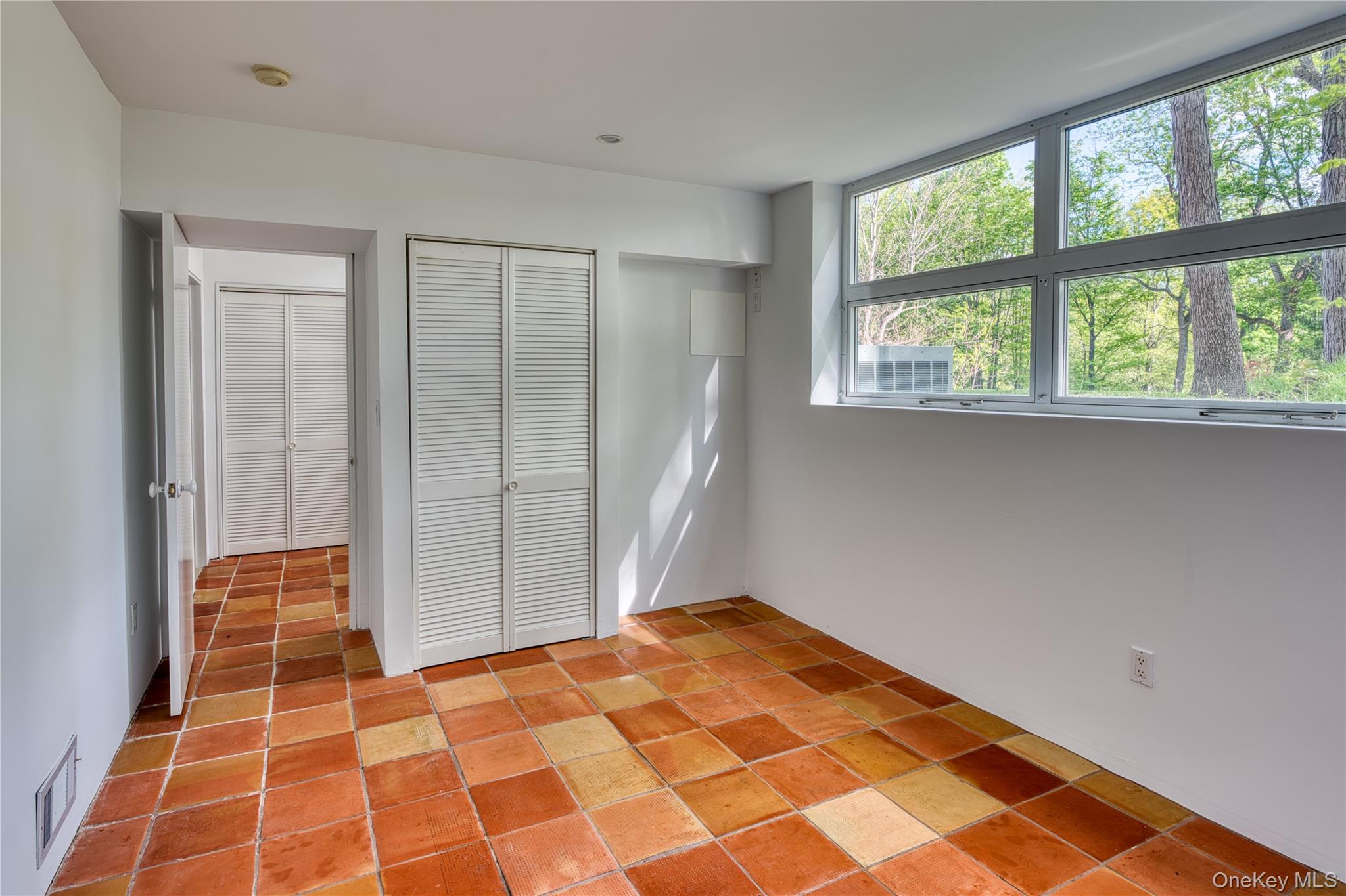 61 Indian Brook Road Garrison, NY 10524 - Photo 16 of 23 a bedroom with a bed and a window