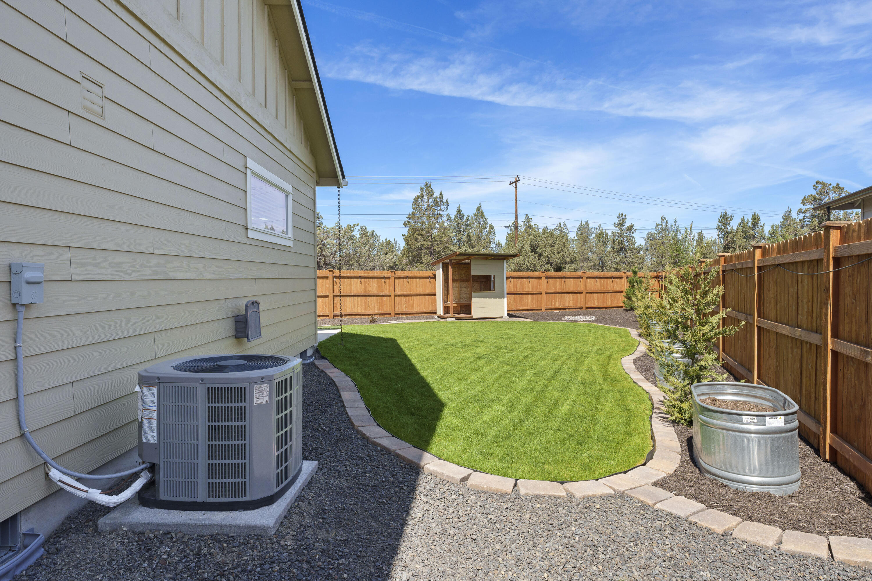 4999 Southwest Yew Place Redmond, OR 97756 - Photo 43 of 50 a view of a swimming pool with a lounge chair