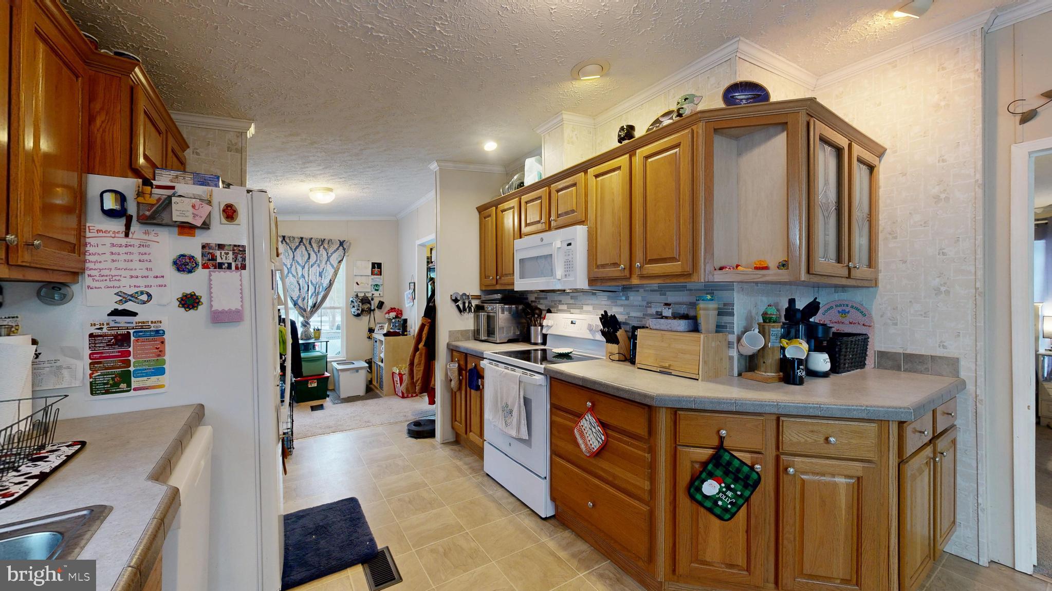 22901 Camp Arrowhead Road Lewes, DE 19958 - Photo 15 of 39 a kitchen with stainless steel appliances granite countertop a sink a stove and a refrigerator