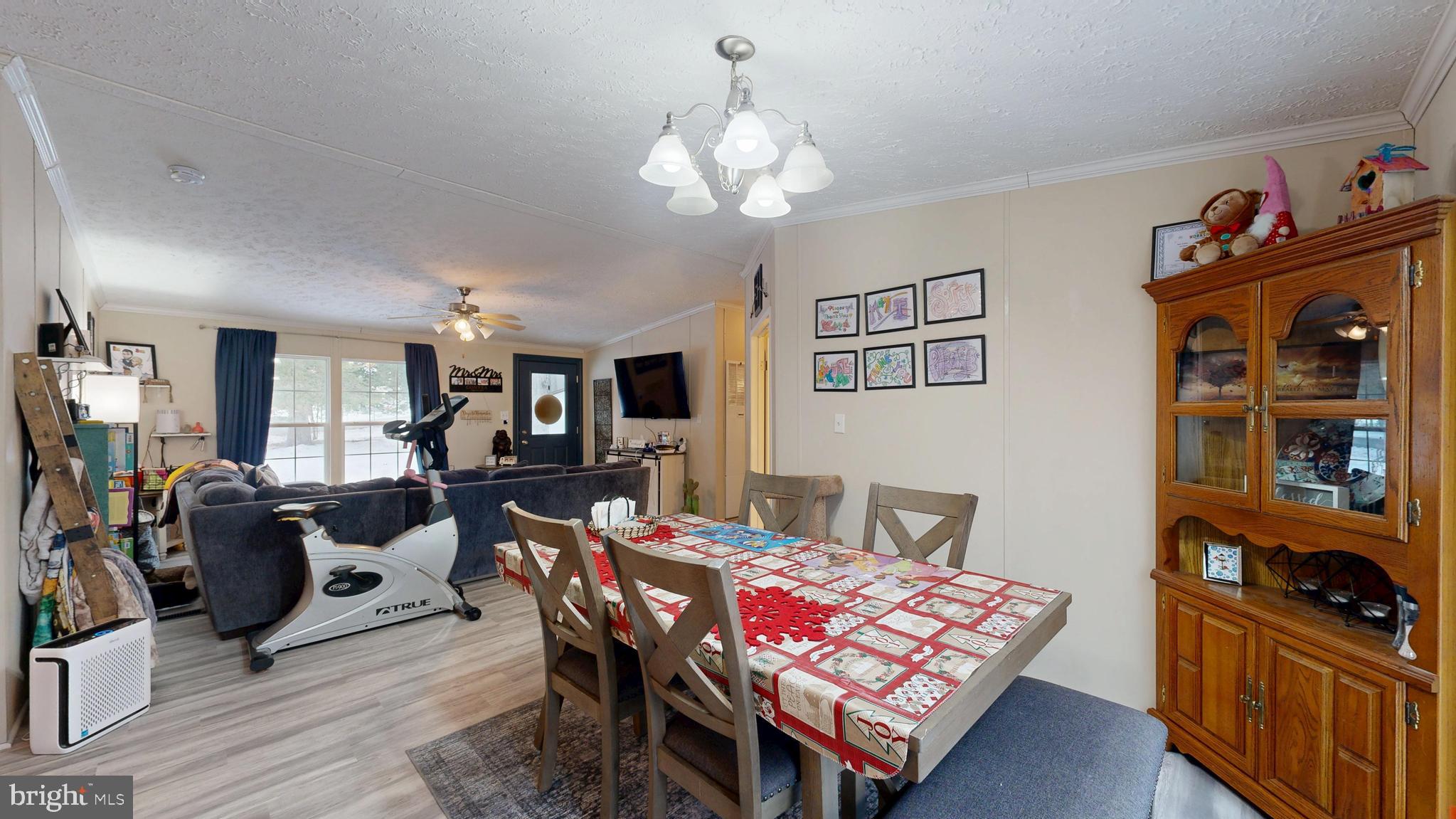 22901 Camp Arrowhead Road Lewes, DE 19958 - Photo 23 of 39 a view of a dining room with furniture and wooden floor