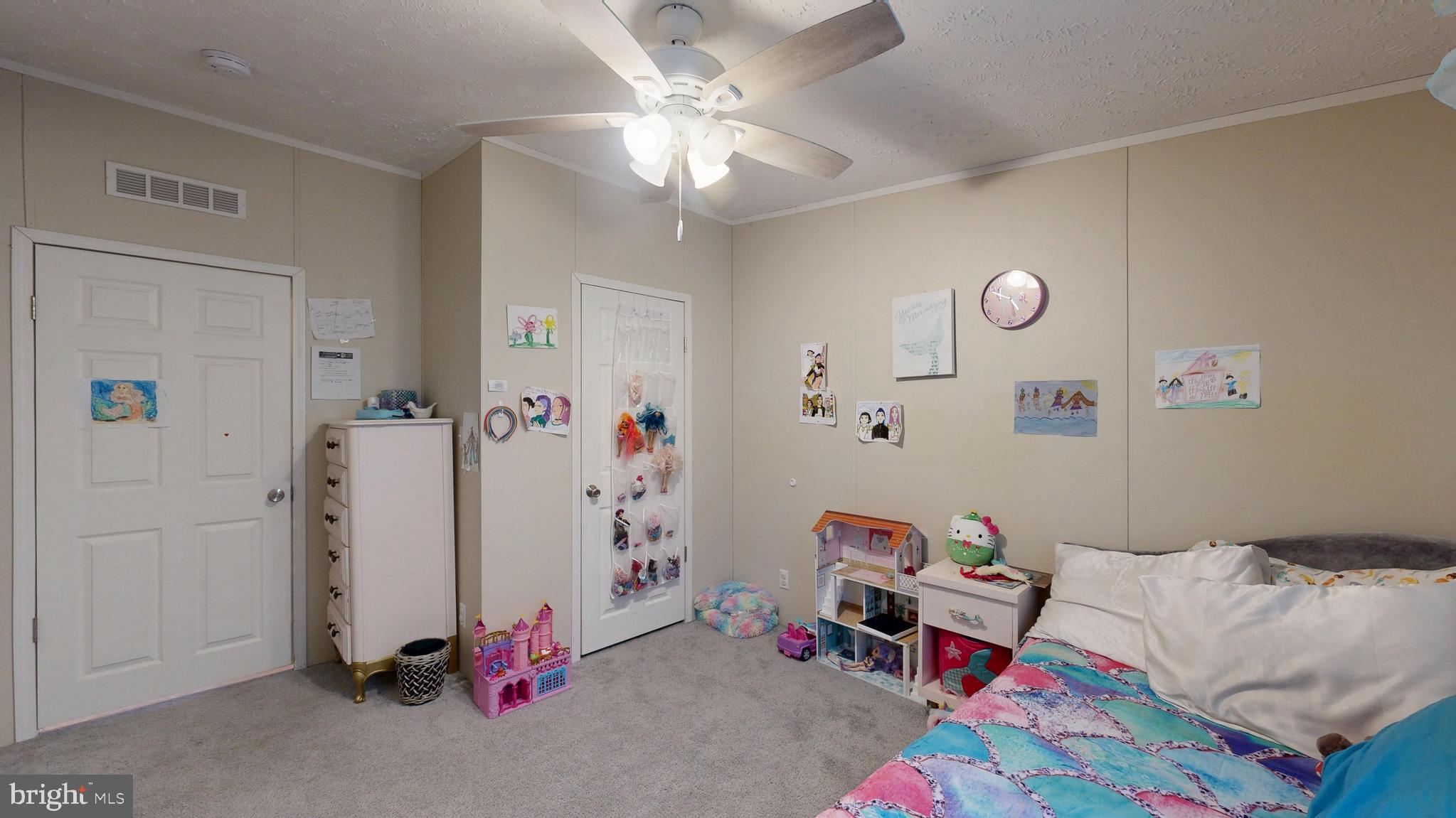 22901 Camp Arrowhead Road Lewes, DE 19958 - Photo 26 of 39 a bed room with a bed and a chandelier