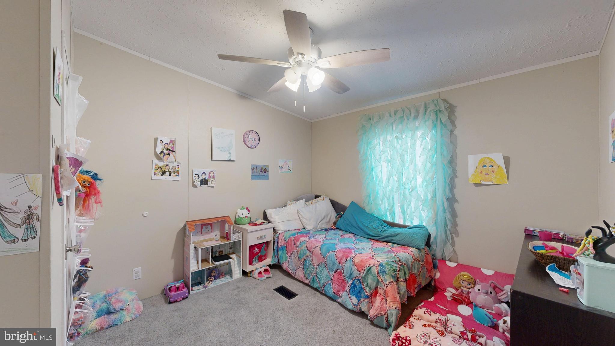 22901 Camp Arrowhead Road Lewes, DE 19958 - Photo 27 of 39 a bedroom with a bed and a chandelier