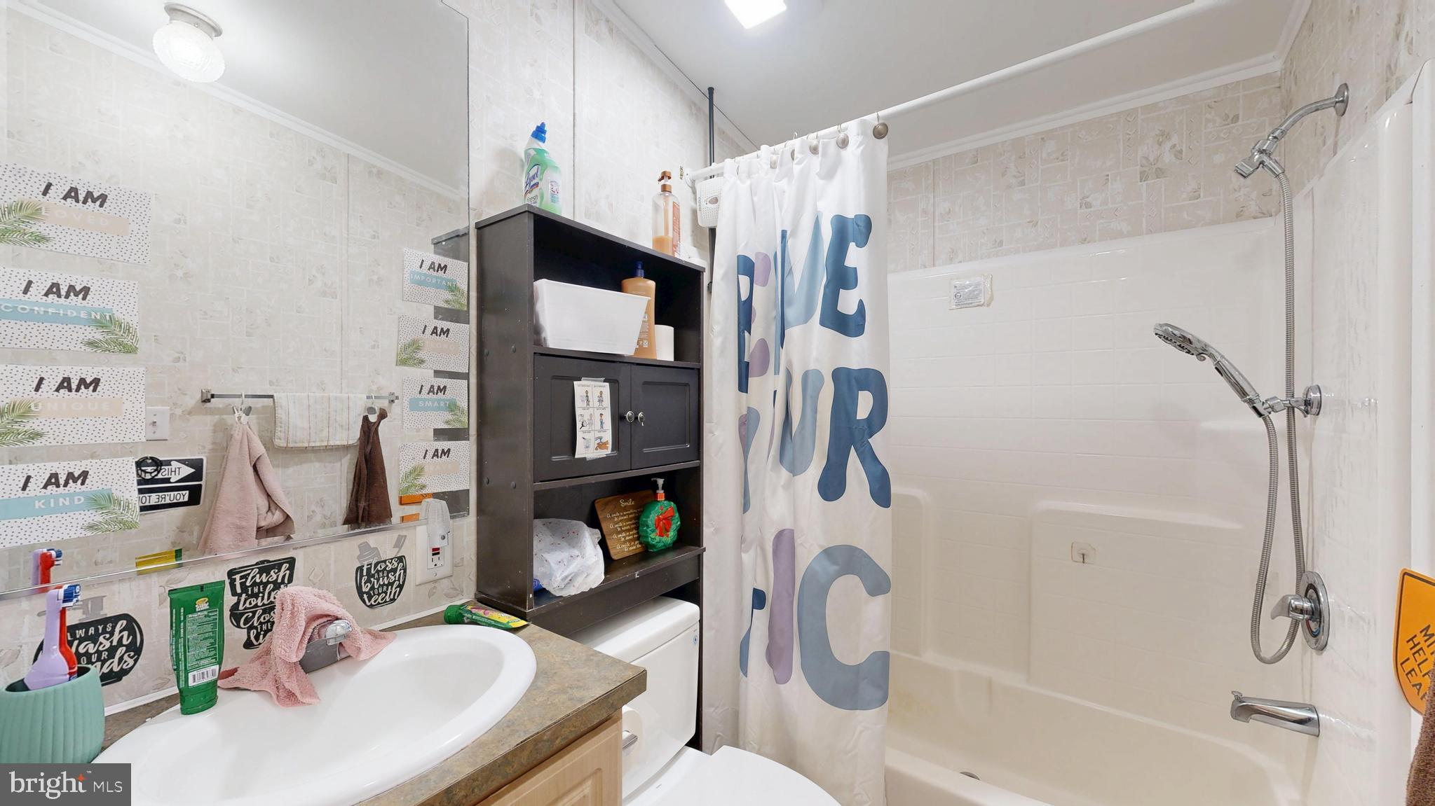 22901 Camp Arrowhead Road Lewes, DE 19958 - Photo 31 of 39 a bathroom with a sink toilet and shower