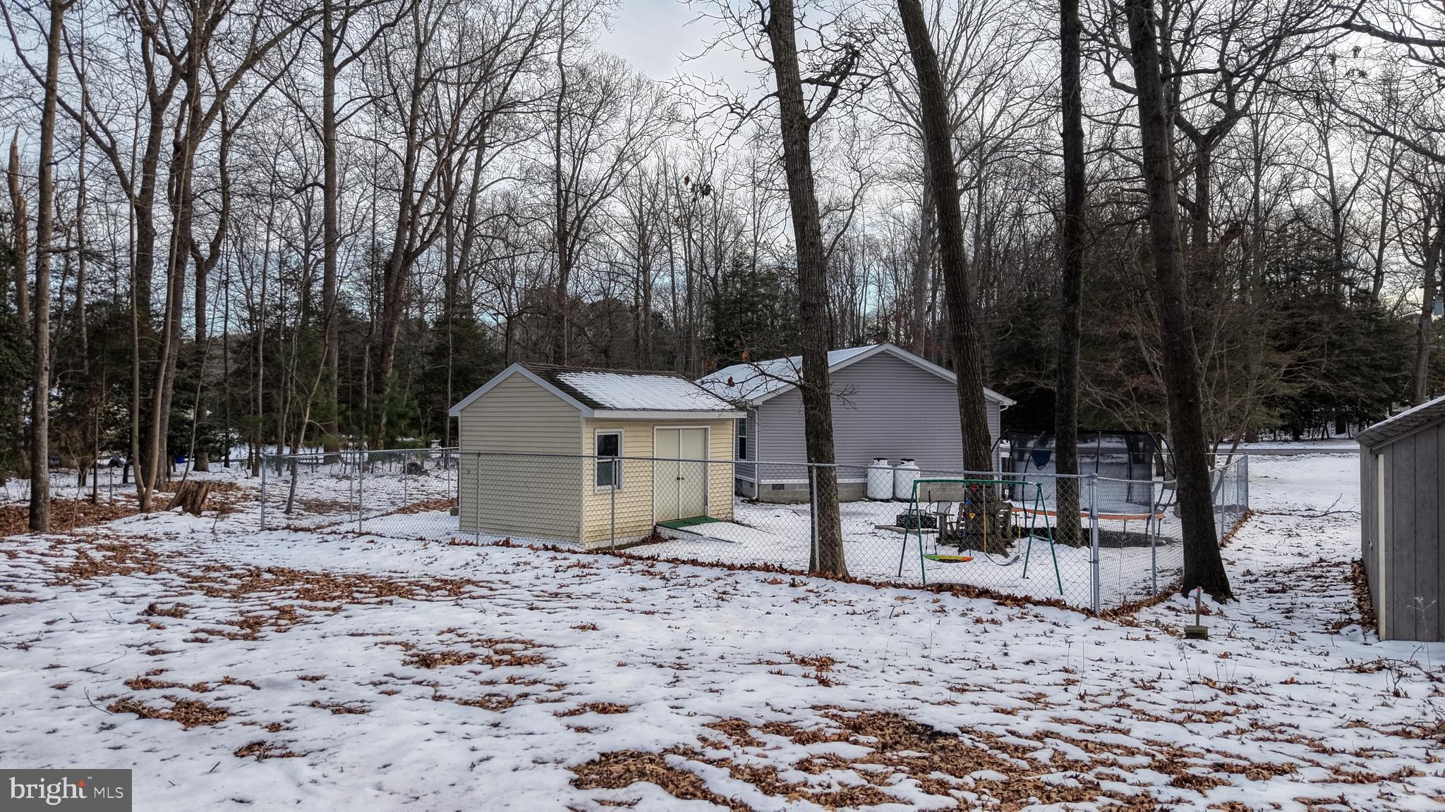 22901 Camp Arrowhead Road Lewes, DE 19958 - Photo 8 of 39 a view of a large house with a yard and large trees