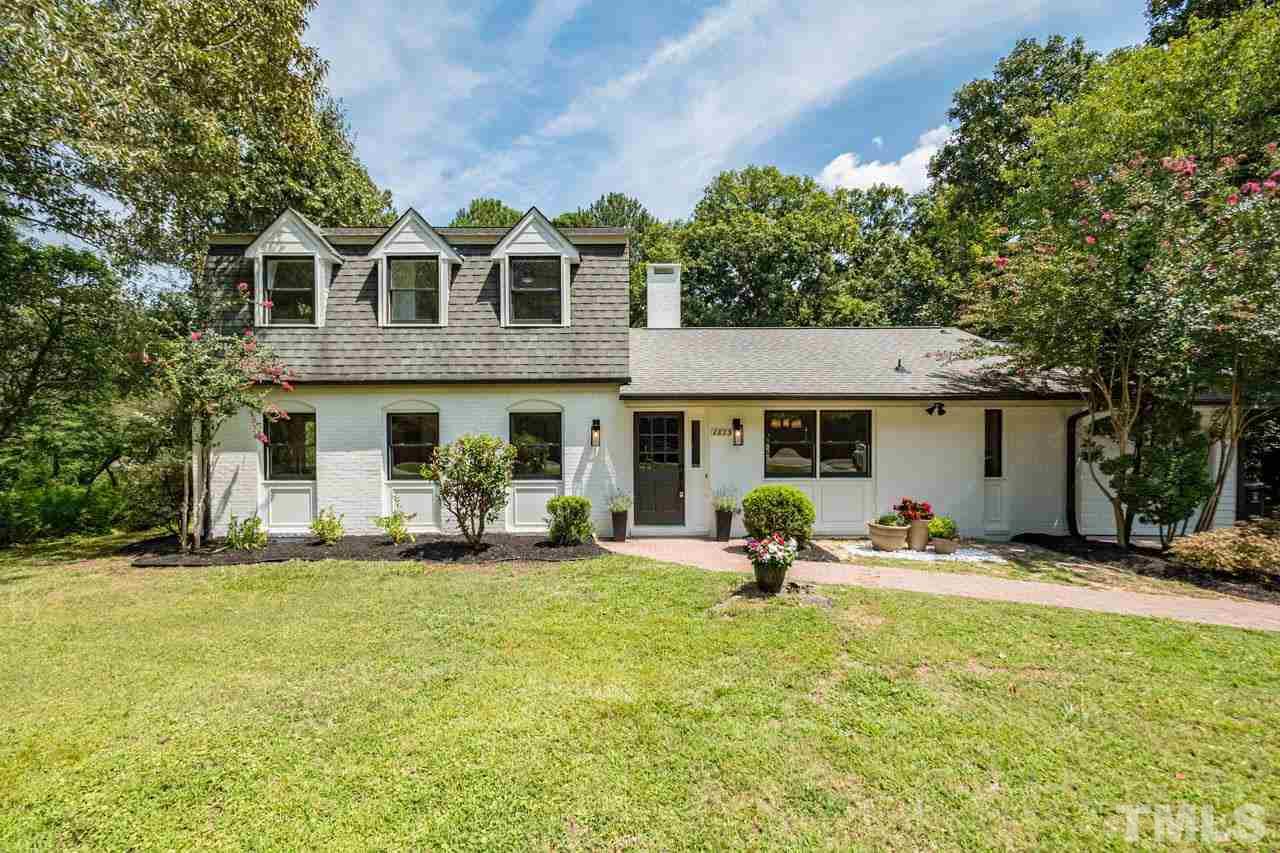 a view of a house with backyard porch and sitting area