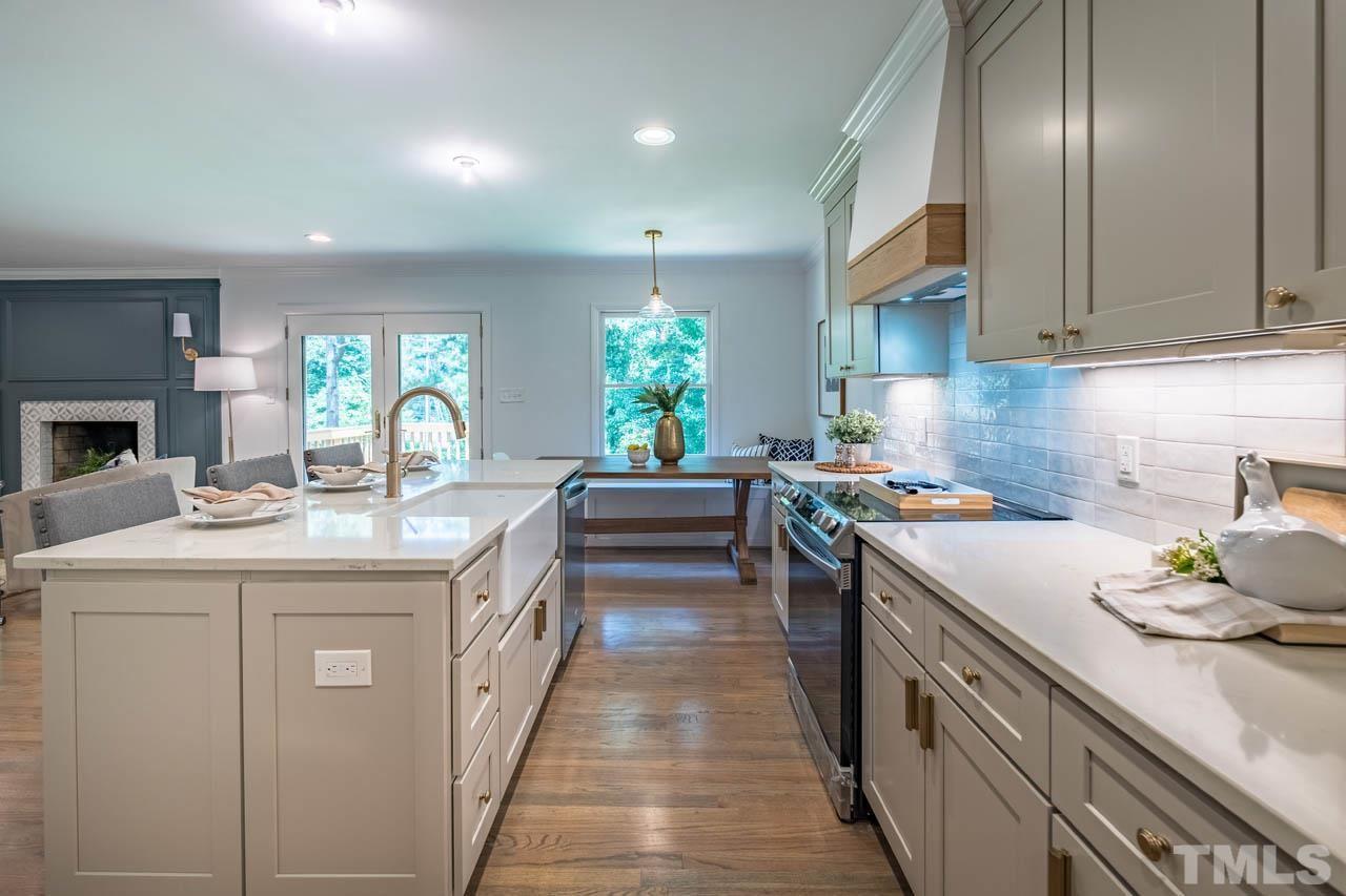 2823 Ridge Road Durham, NC 27705 - Photo 11 of 30 a kitchen with a sink stove and cabinets