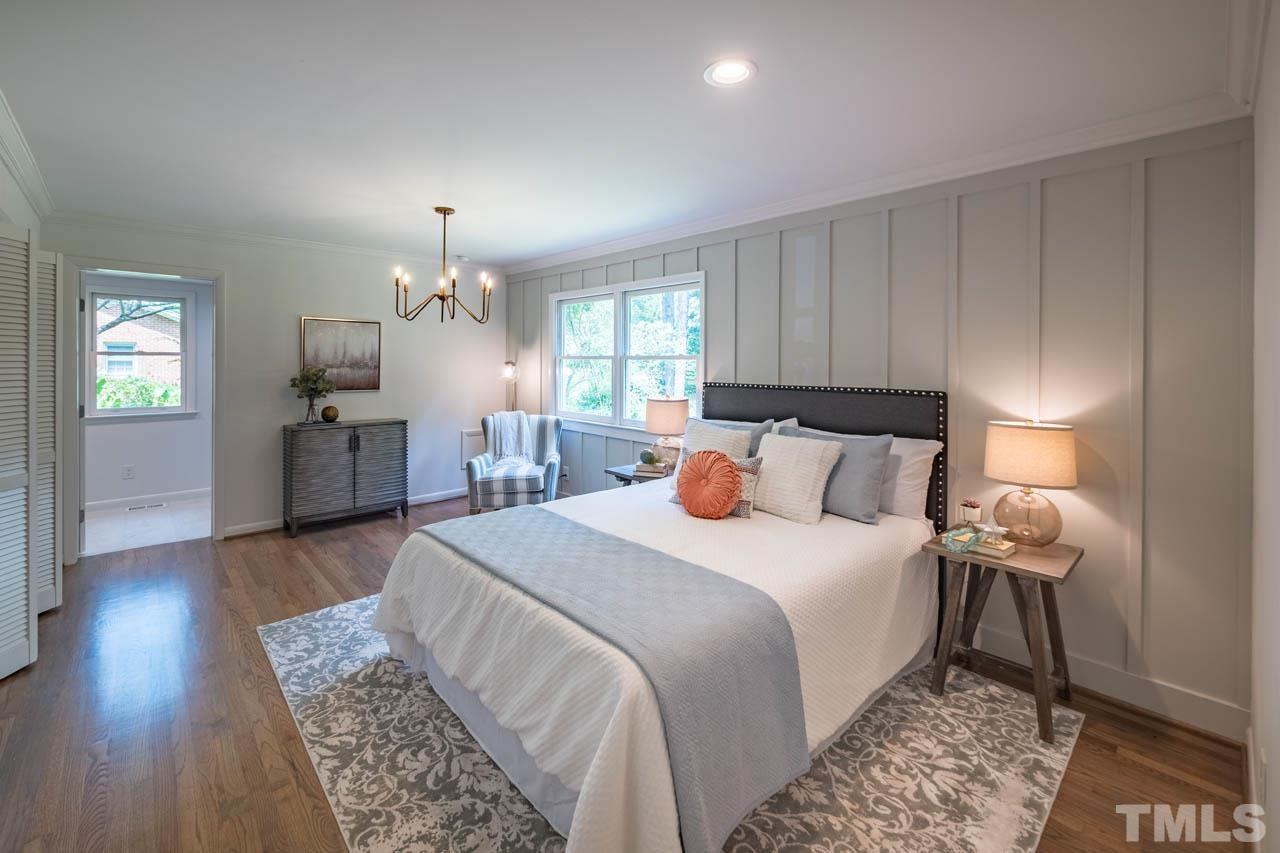 2823 Ridge Road Durham, NC 27705 - Photo 14 of 30 a bed room with a bed and a chandelier