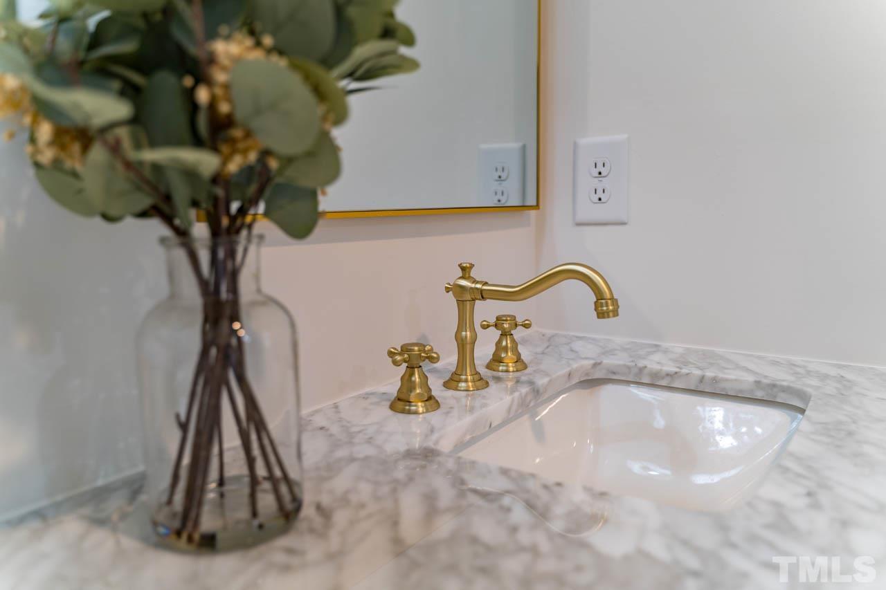 2823 Ridge Road Durham, NC 27705 - Photo 17 of 30 a bathroom with a sink a mirror and a potted plant