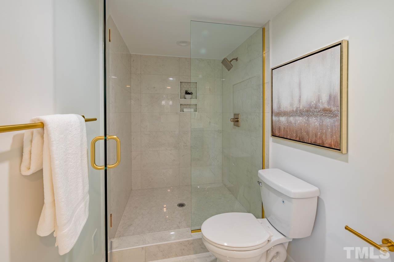 2823 Ridge Road Durham, NC 27705 - Photo 18 of 30 a white toilet sitting next to a bathroom