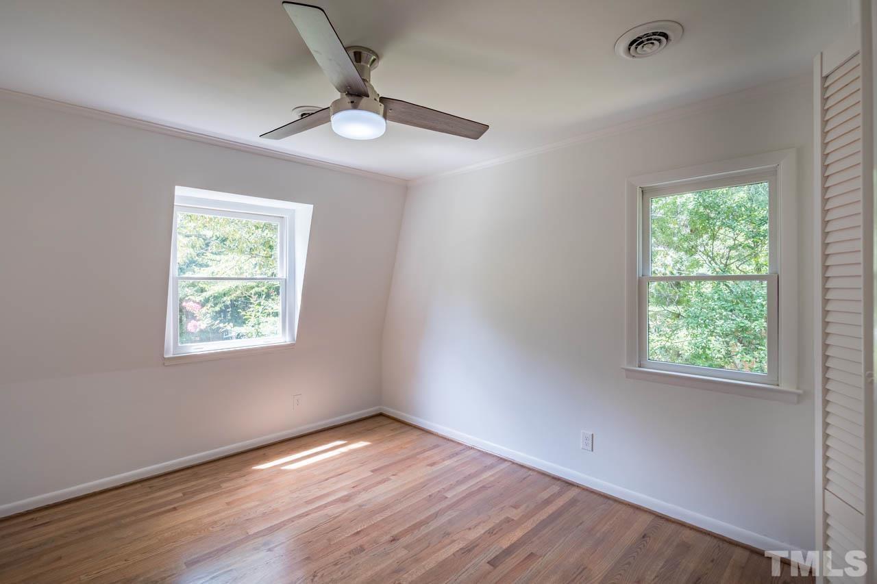 2823 Ridge Road Durham, NC 27705 - Photo 19 of 30 a view of an empty room with wooden floor and a window