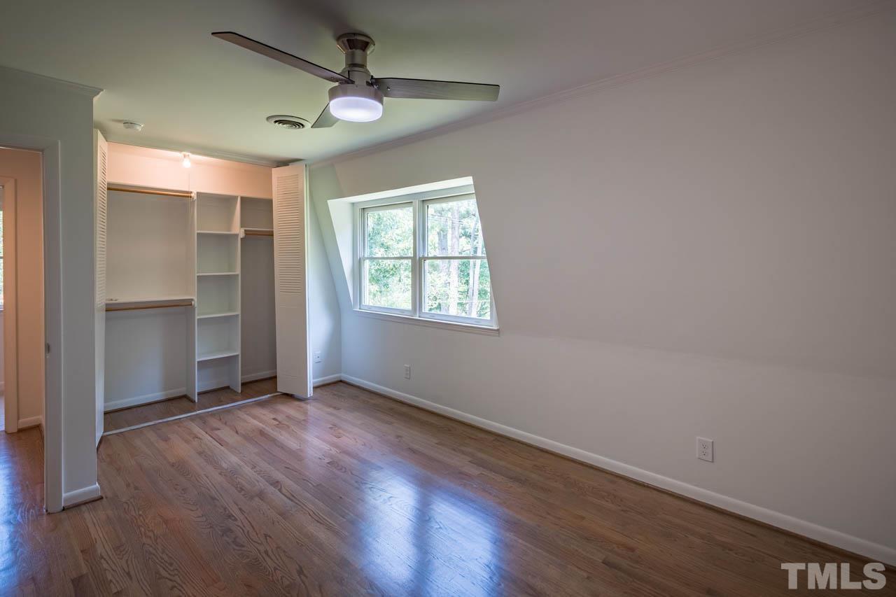 2823 Ridge Road Durham, NC 27705 - Photo 21 of 30 an empty room with wooden floor chandelier fan and windows