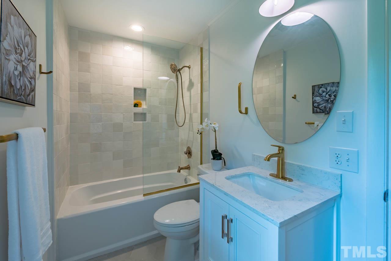 2823 Ridge Road Durham, NC 27705 - Photo 22 of 30 a bathroom with a sink a toilet and shower