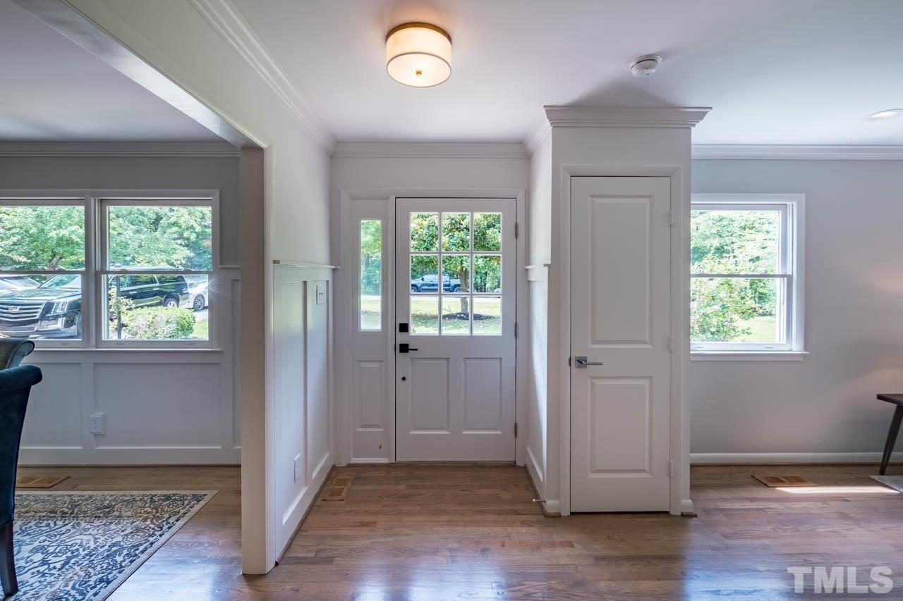 2823 Ridge Road Durham, NC 27705 - Photo 4 of 30 an empty room with wooden floor and windows