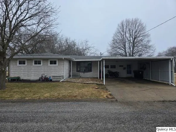 a view of a house with a yard and garage