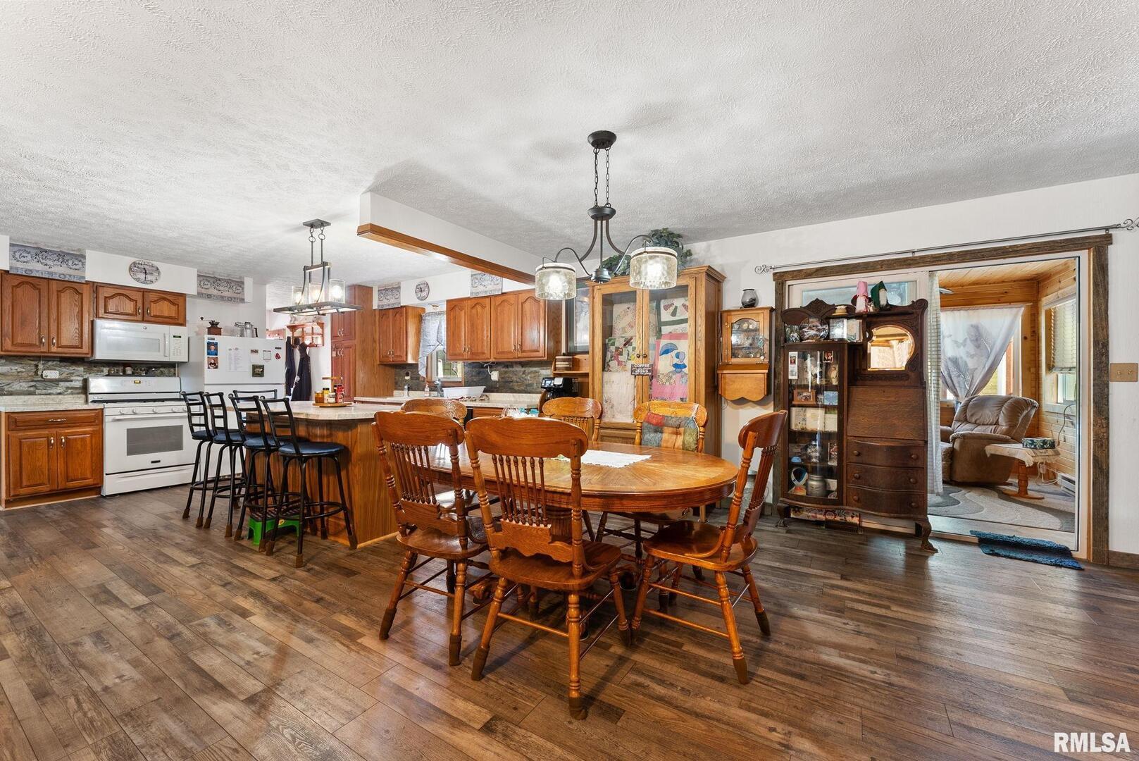 1422 McCloud Road Aledo, IL 61231 - Photo 17 of 44 a view of a dining area with furniture window and wooden floor