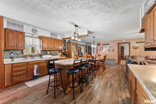 a kitchen with lots of wooden furniture appliances and wooden cabinets