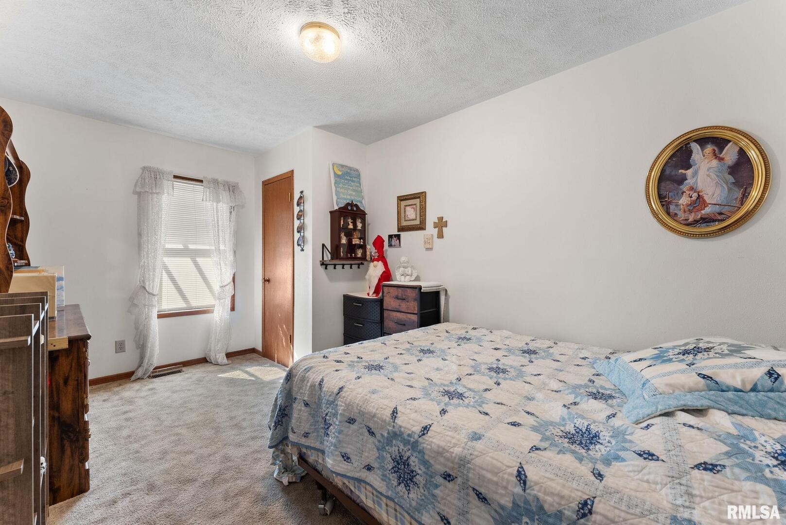 1422 McCloud Road Aledo, IL 61231 - Photo 22 of 44 a bedroom with a bed and a view of bedroom