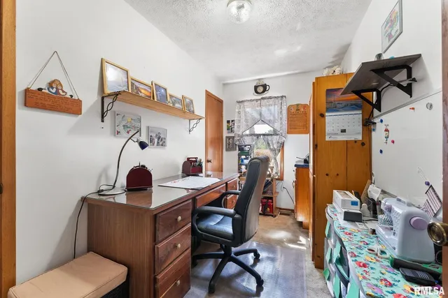 a work room with furniture and rug