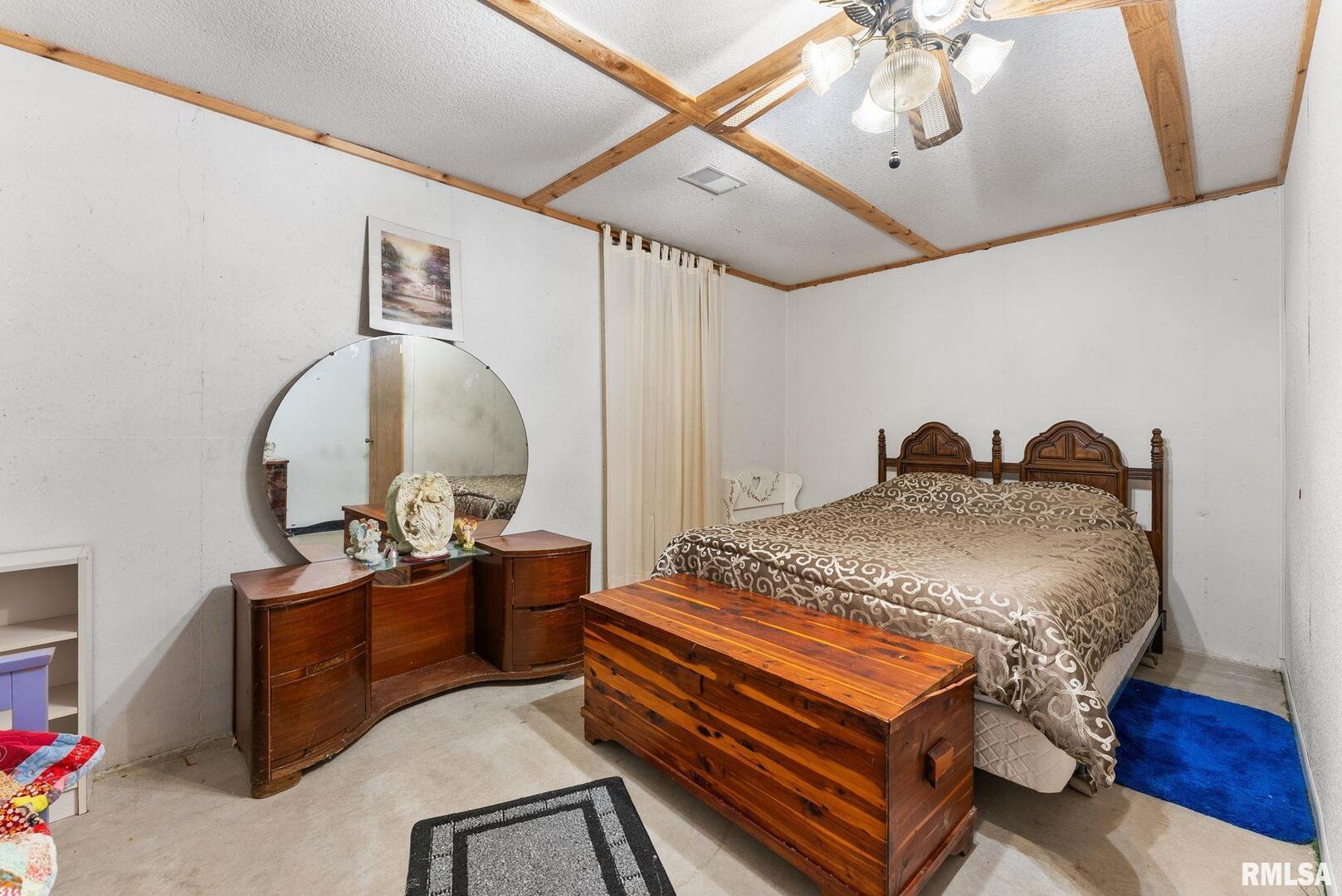 1422 McCloud Road Aledo, IL 61231 - Photo 32 of 44 a bed room with a bed and a chandelier