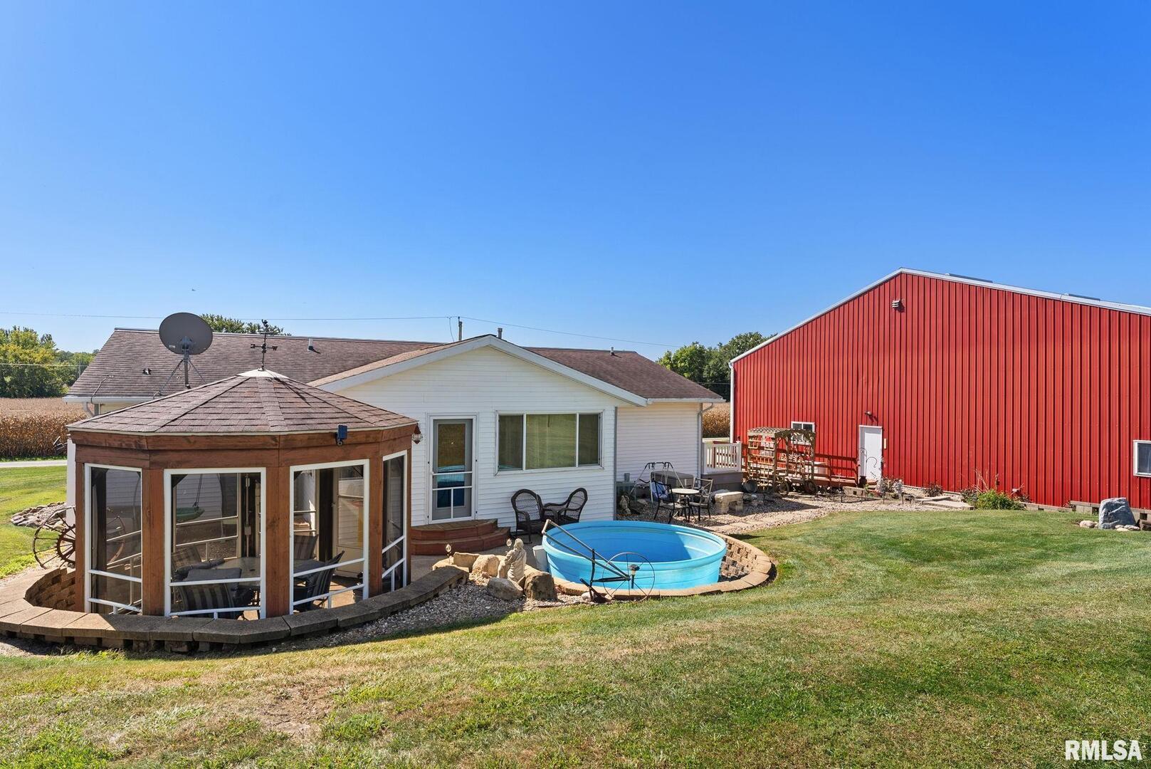1422 McCloud Road Aledo, IL 61231 - Photo 4 of 44 a view of a house with backyard and porch