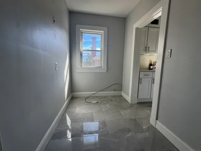 an empty room with a bench and closet