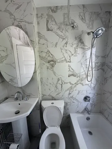 a bathroom with a sink mirror and toilet
