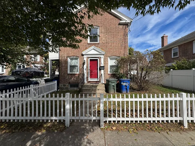 a front view of house with wooden fence