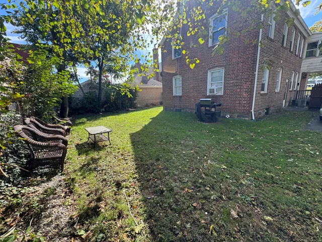 a view of a backyard with plants and a garden
