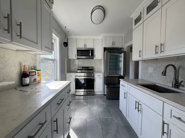 a kitchen with cabinets and stainless steel appliances