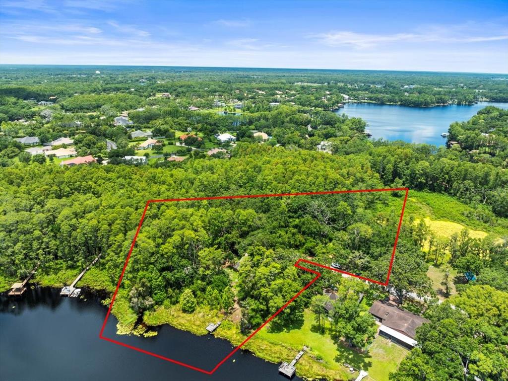 16035 Chastain Road Odessa, FL 33556 - Photo 1 of 31 a view of a lake with houses in the back