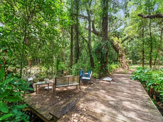 a wooden bench sitting in the middle of a forest