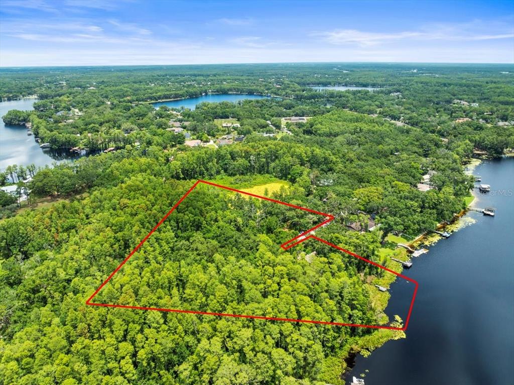 16035 Chastain Road Odessa, FL 33556 - Photo 27 of 31 an aerial view of residential houses with outdoor space and trees