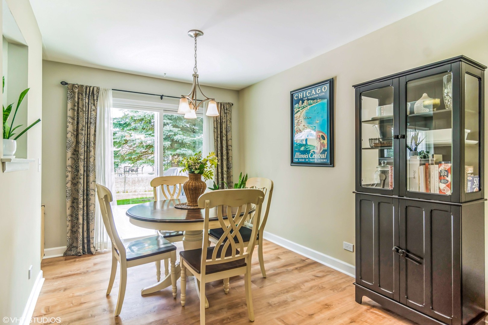1097 Greenridge Road Buffalo Grove, IL 60089 - Photo 7 of 27 a dining room with furniture large windows and a chandelier