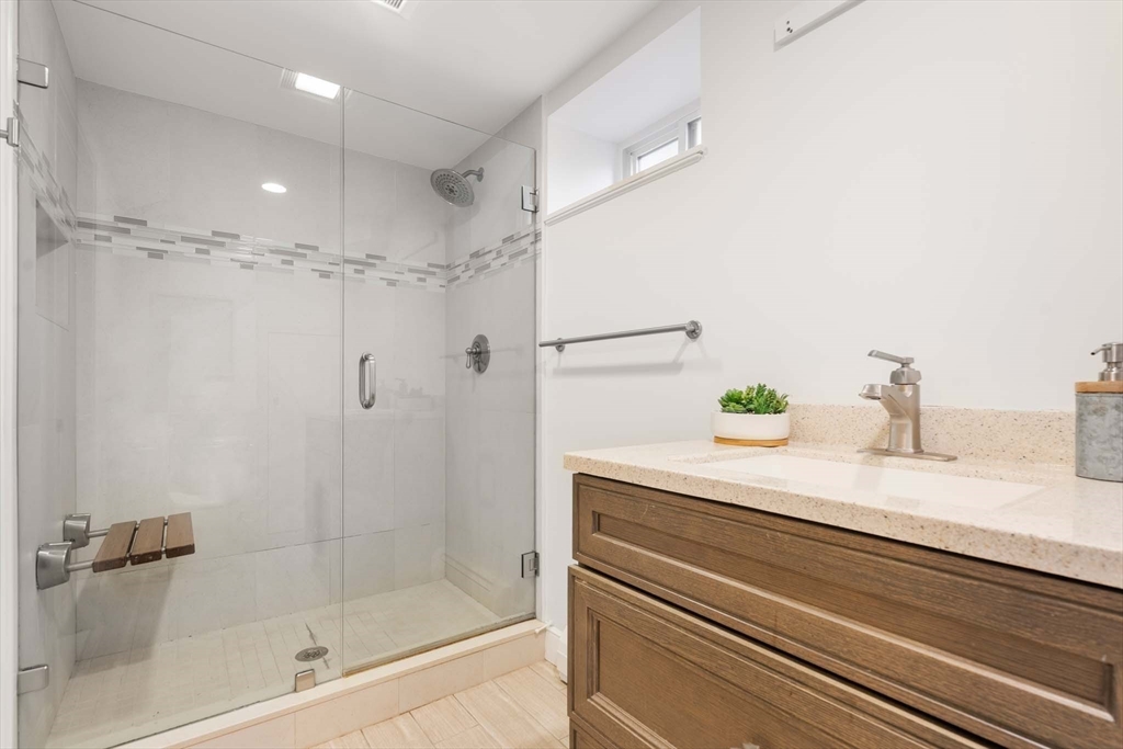 226 Grove Street Brookline, MA 02467 - Photo 17 of 23 a bathroom with a shower and a sink