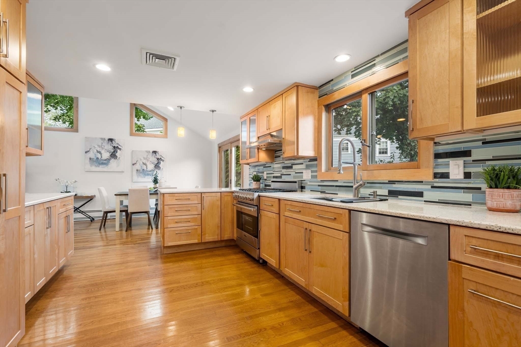 226 Grove Street Brookline, MA 02467 - Photo 5 of 23 a large kitchen with lots of counter top space and stainless steel appliances