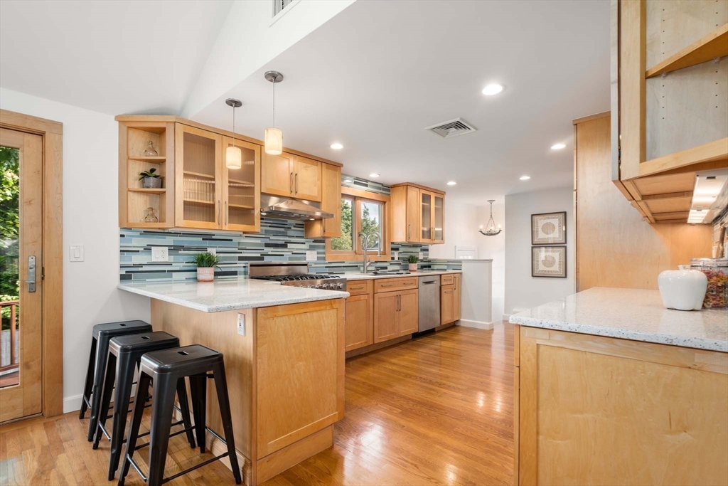 226 Grove Street Brookline, MA 02467 - Photo 6 of 23 a kitchen with stainless steel appliances granite countertop a sink and a stove