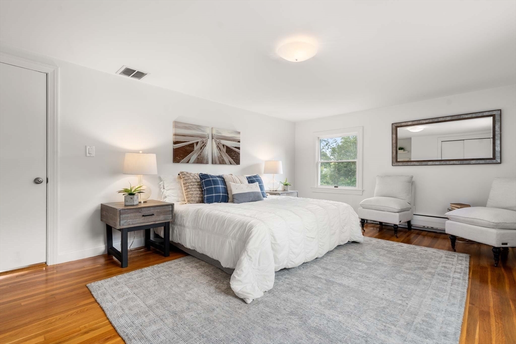 226 Grove Street Brookline, MA 02467 - Photo 10 of 23 a bedroom with a bed and a chair